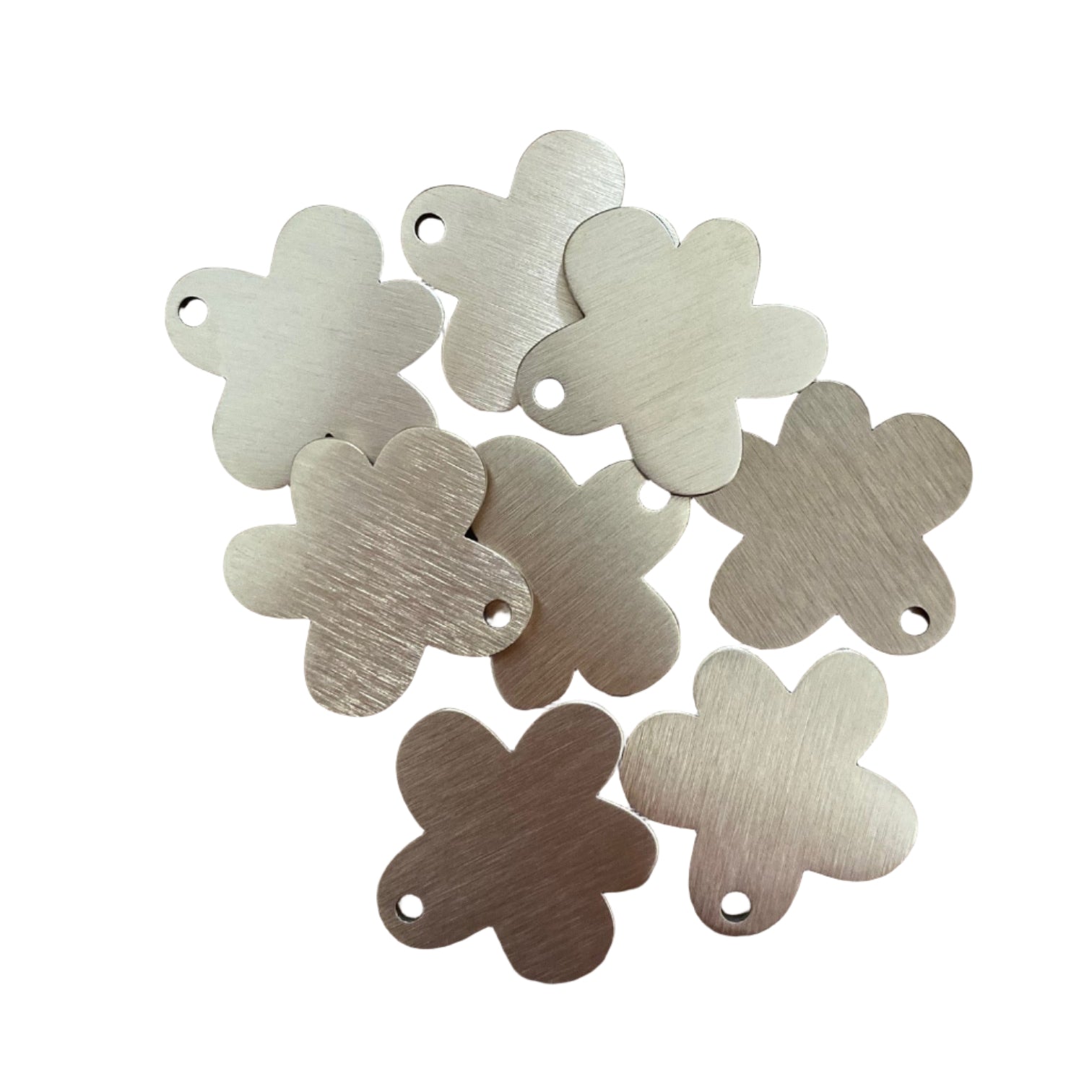 Set of metallic flower-shaped tags on a white background
