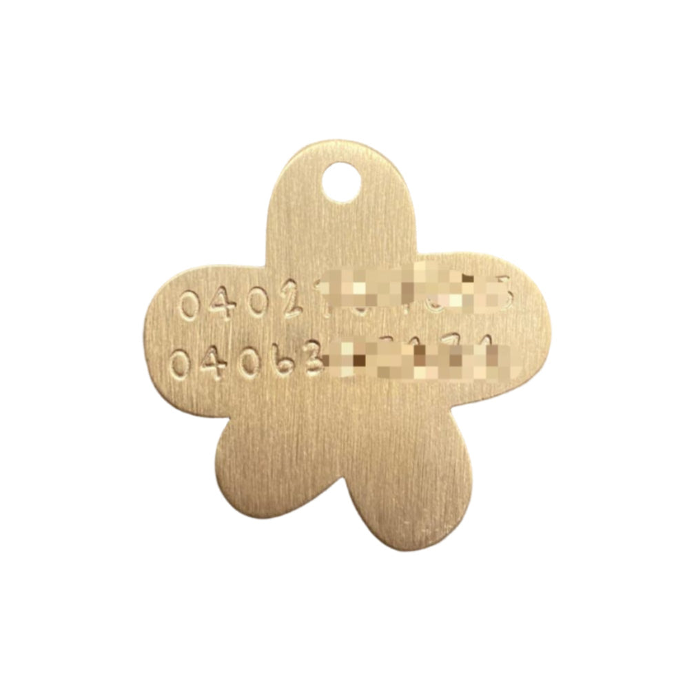 Gold flower-shaped tag with engraved numbers on a white background